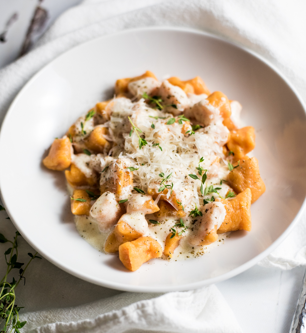 Homemade sweet potato gnocchi in brown butter cream sauce is much simpler to make than you think! It is super delicious and loaded with flavor and texture!