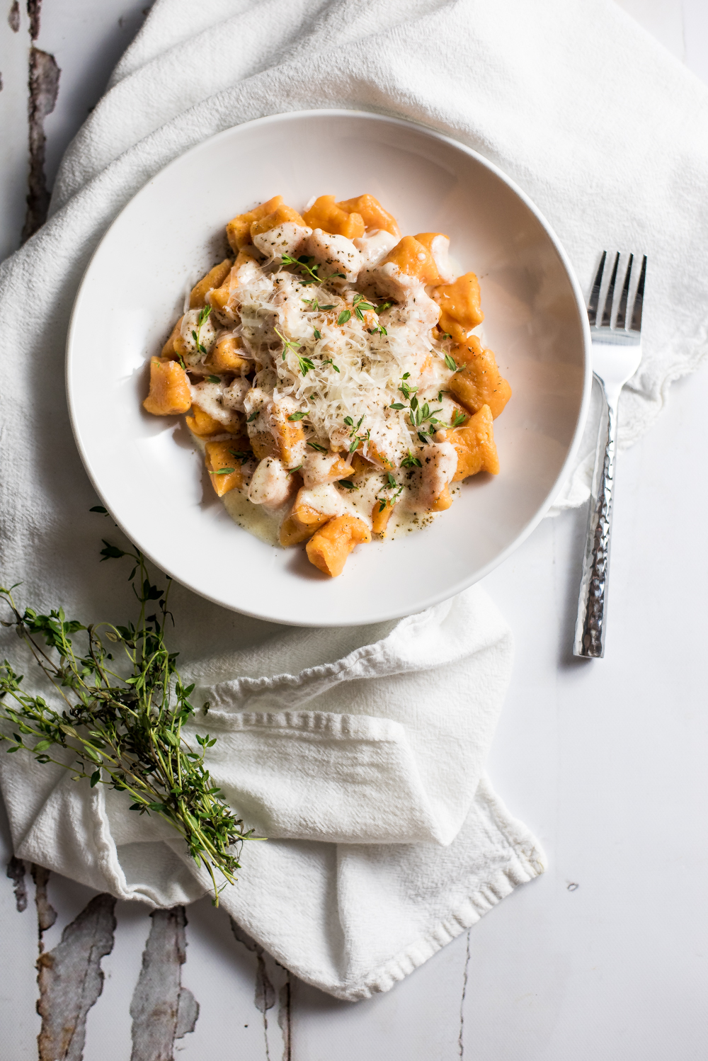 Homemade sweet potato gnocchi in brown butter cream sauce is much simpler to make than you think! It is super delicious and loaded with flavor and texture!