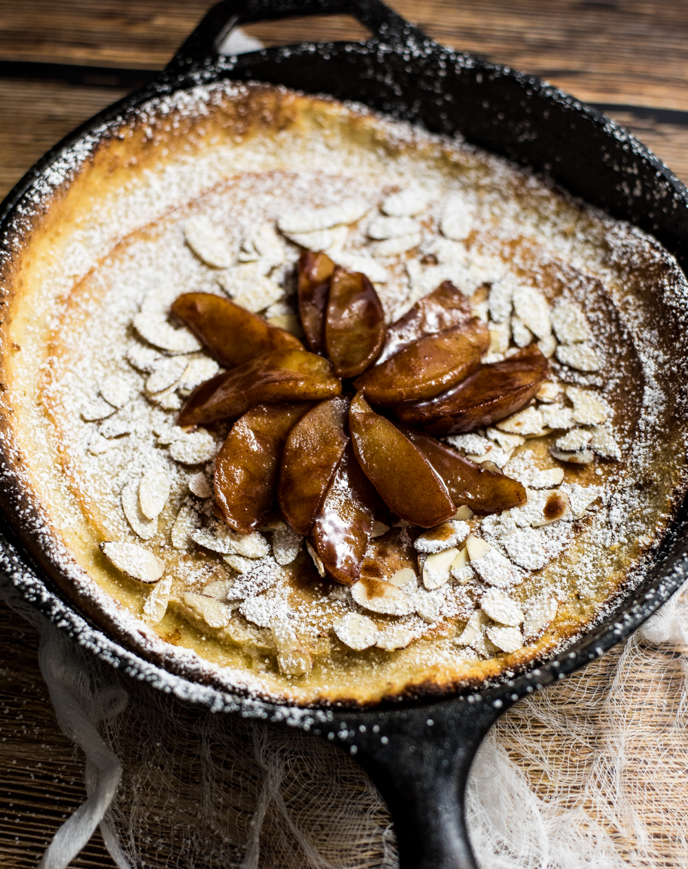 Spiced Apple Dutch Baby is a the perfect fall spin on the classic dutch baby. It is loaded with cinnamon and cardamom and topped with spiced roasted apples!