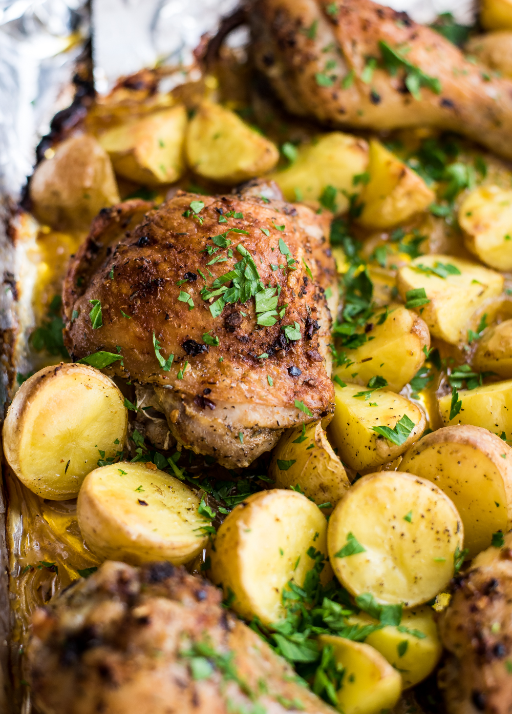 Spicy garlic chicken and potatoes sheet pan dinner is the perfect quick weeknight meal that's simple to make and loaded with flavor!