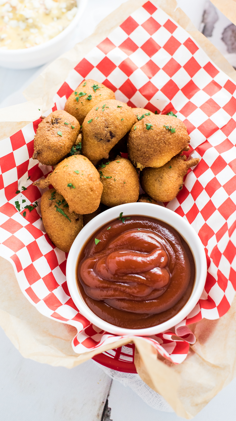 Chili cheese corn dogs are a fun twist on the classic finger food. They are bite-sized morsels that are smothered in a homemade beef queso!