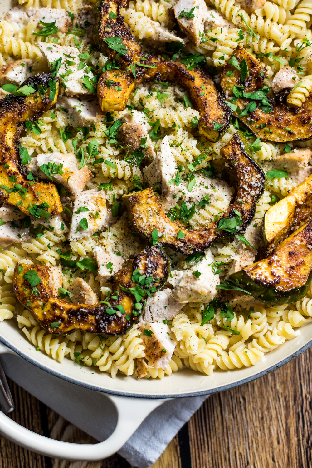 Chicken alfredo pasta with caramelized acorn squash is the perfect fall spin on traditional chicken alfredo. It's one big bowl of comfort!