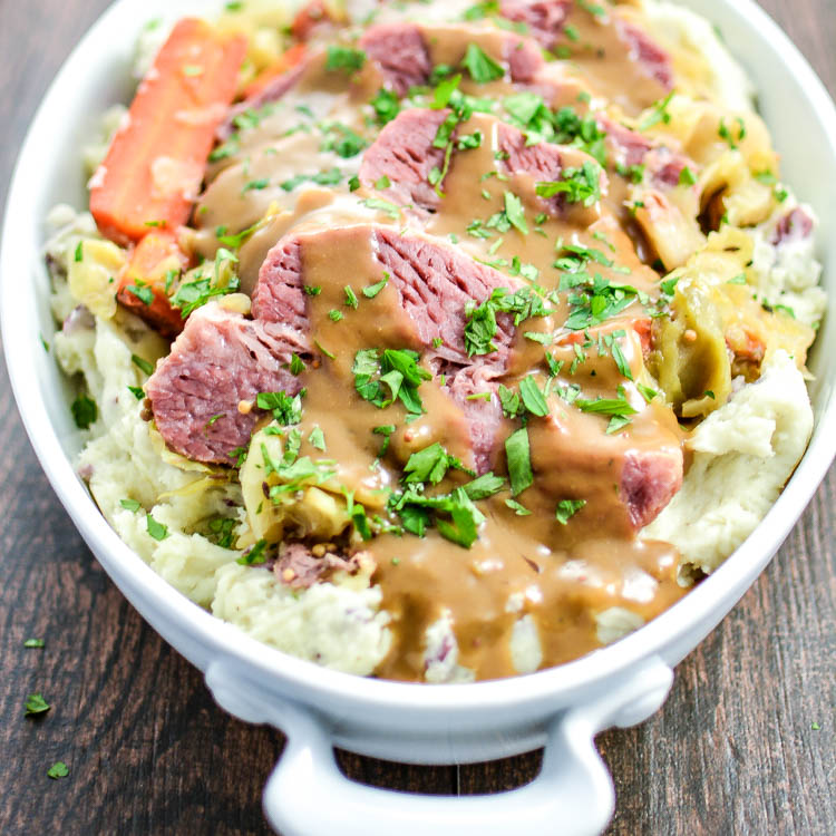Slow Cooker Corned Beef and Cabbage with Mashed Red Potatoes and Dijon Stout Gravy is the perfect Irish meal to get you through St. Patrick's Day! | www.cookingandbeer.com