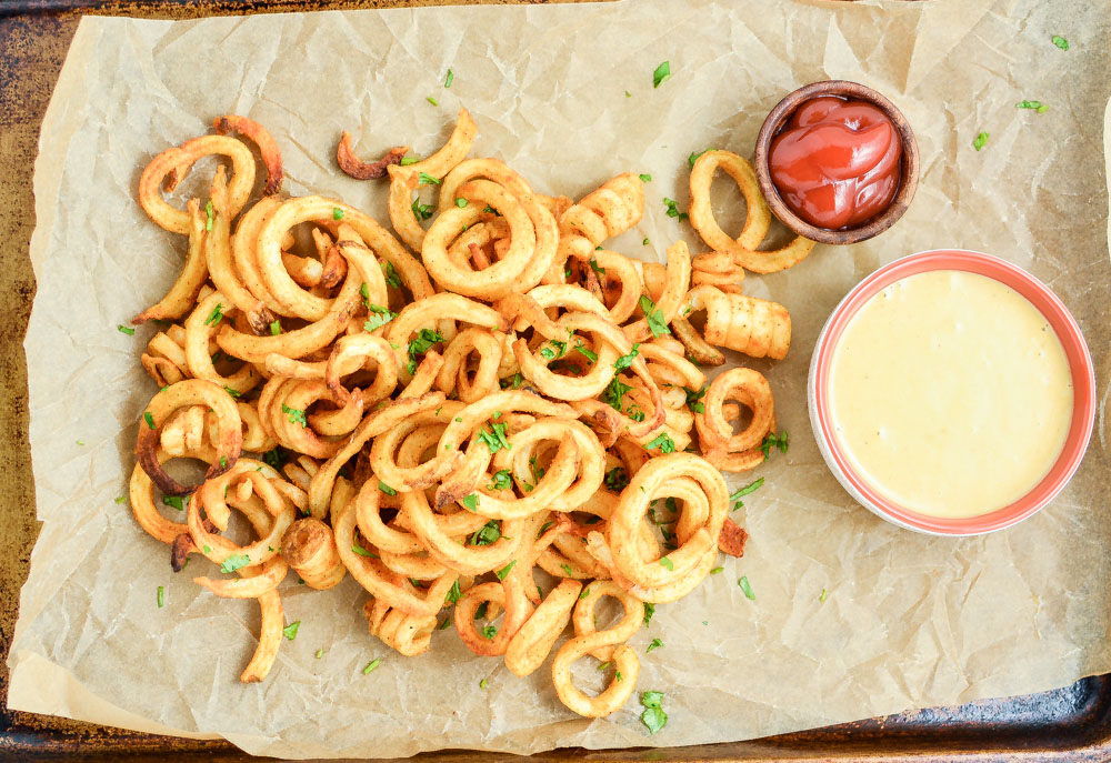 Baked Curly Fries with Mustard-BBQ Dipping Sauce are so easy to make at home and are the perfect side dish!