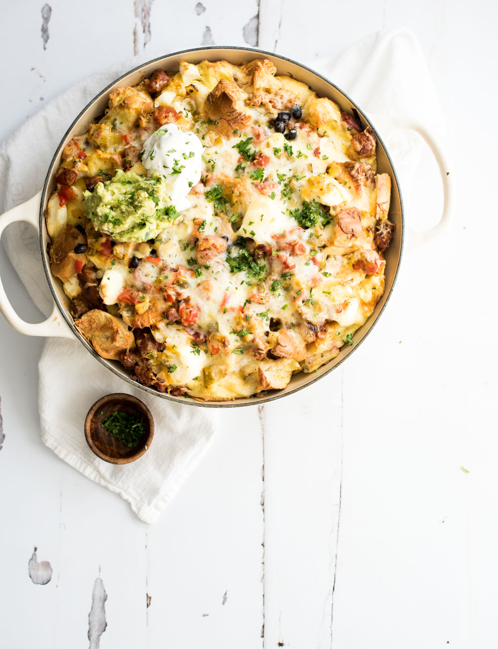Put a large fun twist on your next breakfast casserole with this huevos rancheros breakfast strata. It's popping with flavor and perfect for a crowd!