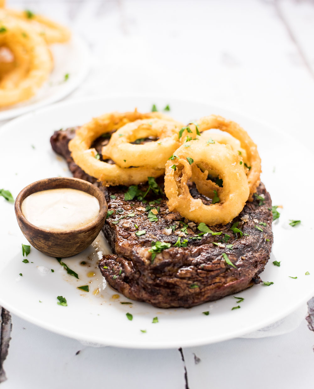 Create a meal worthy of a steakhouse with this chili-rubbed ribeye Steak with beer-battered onion rings!