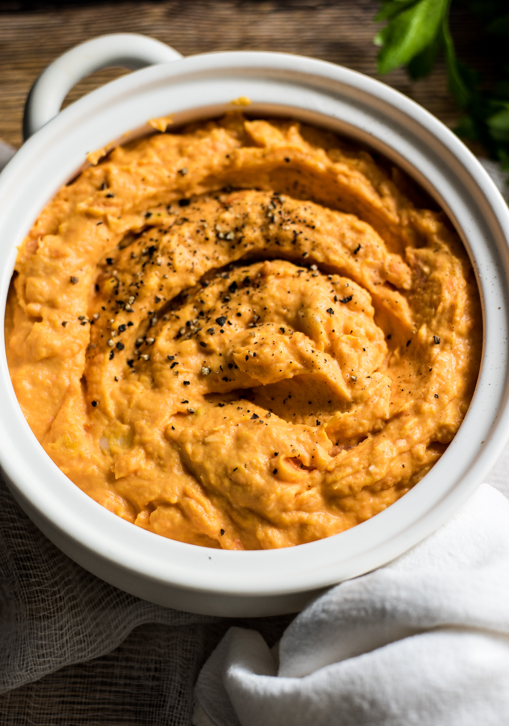Roasted garlic mashed sweet potatoes and carrots is the perfect side dish to serve this fall!