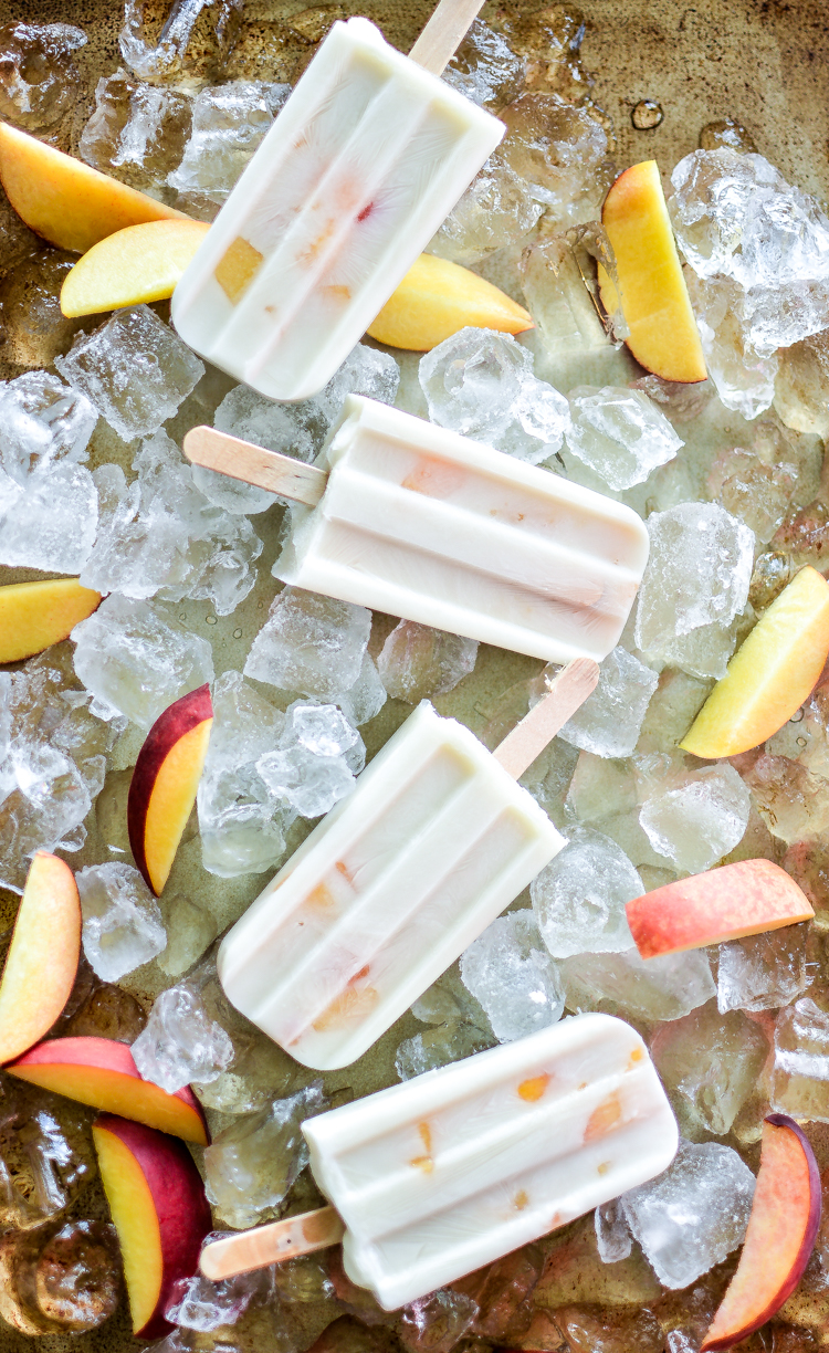 These vegan peaches and cream ice pops are the perfect recipe to help you cool down this summer. They are light, healthy and utterly delicious! | www.cookingandbeer.com