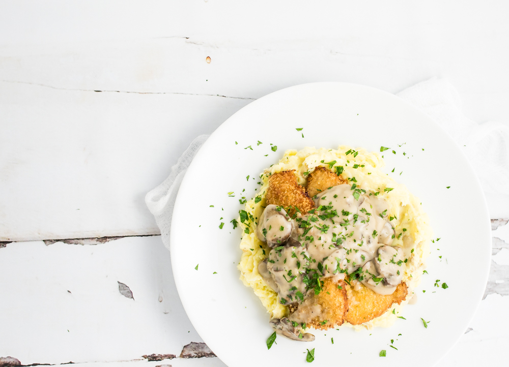 Pork Schnitzel with Mushroom Stout Gravy is a twist on a classic Austrian dish that is loaded with flavor and coated with crispiness!