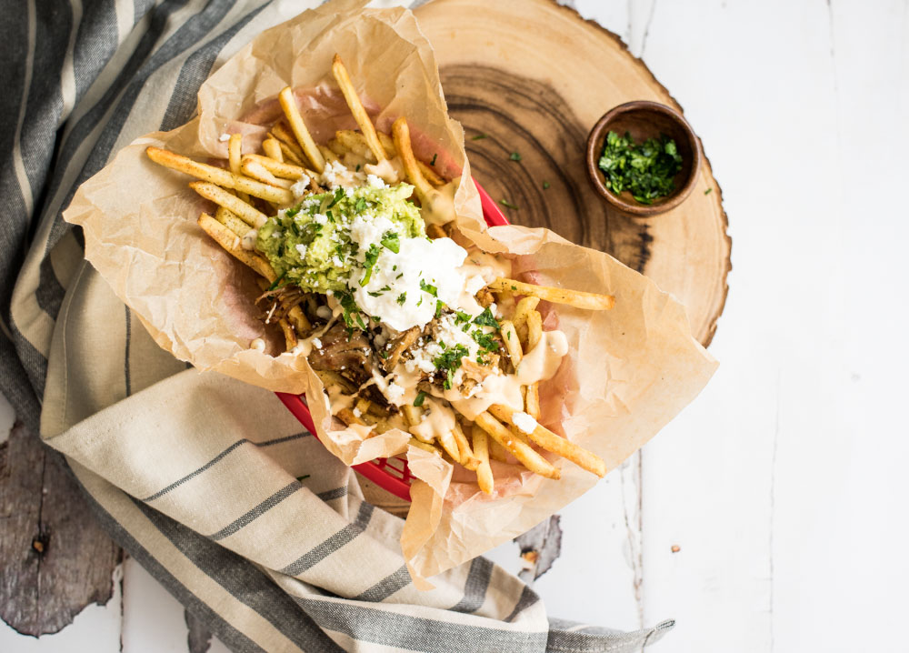 These loaded pork carnitas street fries are the perfect side dish for a Mexican-themed dinner or an appetizer for a small get together!